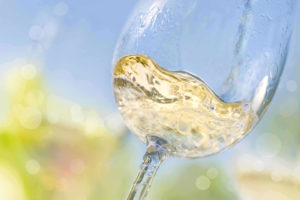 Close up of pouring white wine in a glass