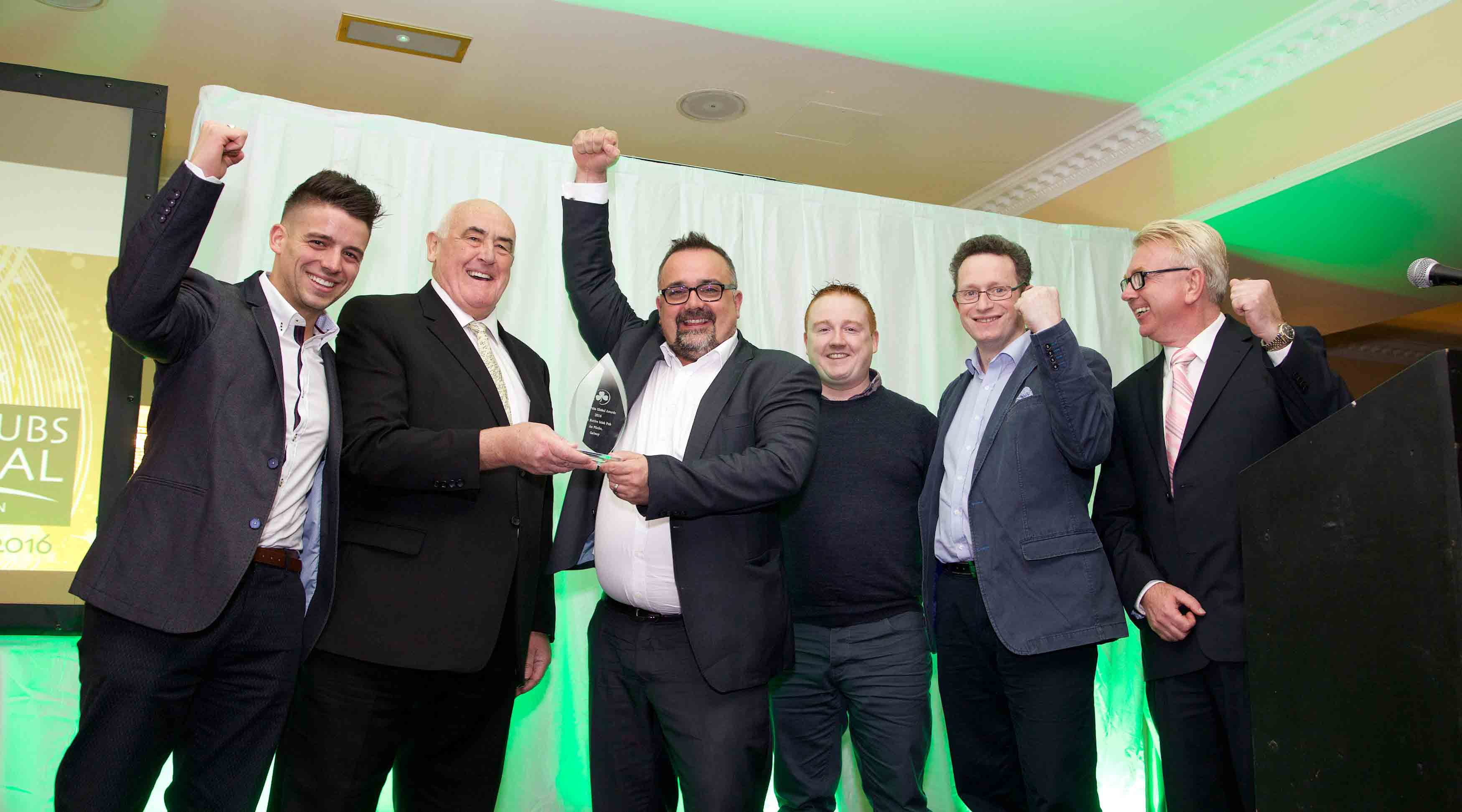The team from An Púcán celebrate their win with Senator Billy Lawless (2nd left) and (far right) MC for the evening mediateam's John McDonald.