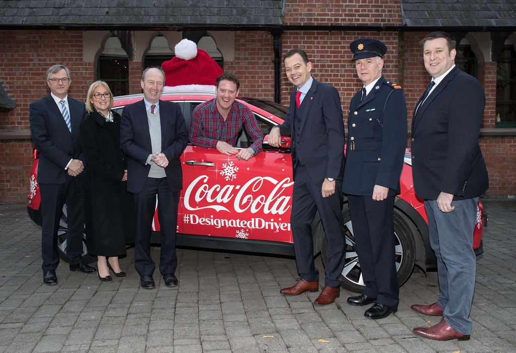 From left: Coca-Cola’s 12th Annual Designated Driver campaign was launched with the help of the Chief Executive of the Irish Hotels Federation Tim Fenn, the Chief Executive of the Road Safety Authority Moyagh Murdock, the Minister for Transport, Tourism and Sport Shane Ross TD, comedian Andrew Stanley, the General Manager of Coca-Cola HBC Ireland and Northern Ireland Matthieu Seguin, Superintendent of Garda National Roads Policing Bureau Con O’Donohue and RAI Chief Executive Adrian Cummins.