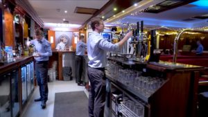 The staff and customers at Jobstown House ‘frozen’ live in the act of drinking their beer while an unmoving staff pull pints and pour drinks.