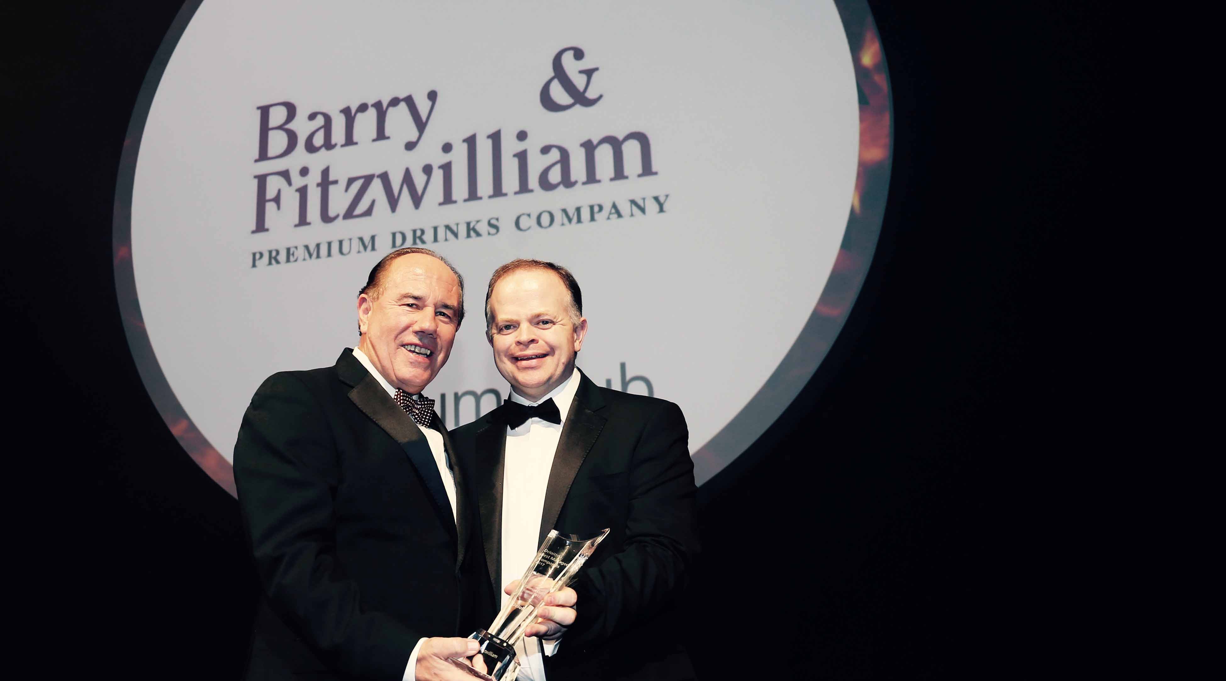 From left: Barry & Fitzwilliam’s Michael Barry collects at Platinum Award for Best Managed Company from Deloitte Partner Richard Howard.