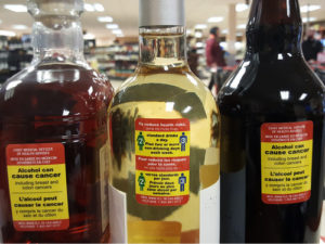 Yukon tested affixing cancer warning labels to containers of alcohol as part of an eight-month test. The test was halted after about a month.