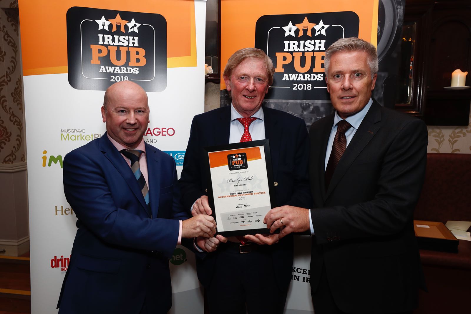 From left: LVA Chairman Alan Campbell presents John Brady of Brady’s in Shankhill with the Outstanding Customer Service Award for Dublin with sponsor Heineken’s Jerome O’Donovan.