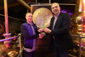 Patsy from Bowe's Bar in Dulbin receives the Irish Whiskey Bar of the Year from Bushmills' Master Distiller Colum Egan.