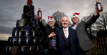 Launching the season to be jolly will be Hinch Distillery’s unveiling of its unique 24ft tree made from up-cycled whiskey barrels and topped off with sparkling lights and a luscious bow. From left: Hinch Distillery Director Patrick Cross, Chairman Dr Terry Cross OBE and General Manager Cathal McNicholl.