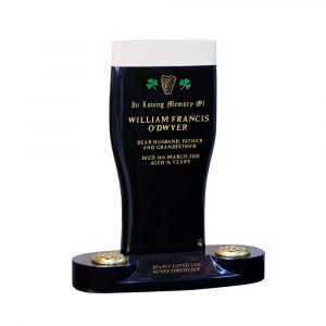The Pint of Plain memorial stone includes two traditional Irish symbols - the Celtic harp and green painted shamrocks - and an 80-character inscription.