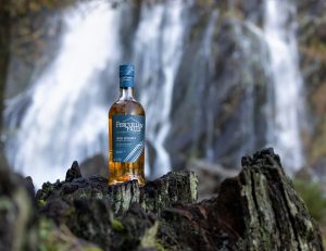 Fercullen Shoot - bottle on rock waterfall in background 2.jpg